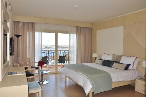 a bedroom with a large bed and a balcony at Eden Rock Hotel Namaa Bay in Sharm El Sheikh