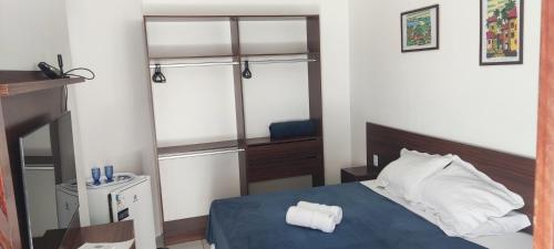 a bedroom with a blue bed and a mirror at Da Silva residência à 200 metros da praia do Bessa in João Pessoa