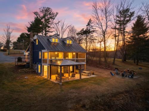 a house with a group of people sitting in front of it at Riverfront Fire Pit Hot Tub Fishing Kayaks PacMan in Hopkins Spring