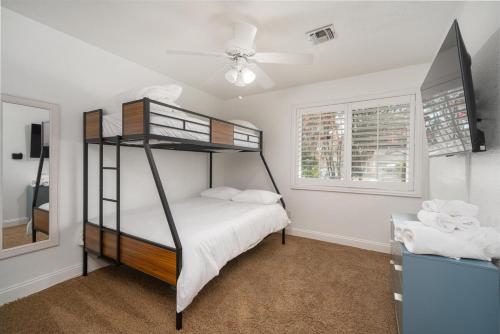 a bedroom with a bunk bed and a mirror at Your Poolside Hideaway in Bakersfield