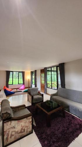 a large living room with a couch and a table at Cypress Resort Cipanas in Barukupa