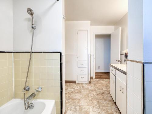 a bathroom with a shower and a bath tub at The Nest with Firepit & Backyard Oasis in Klamath Falls