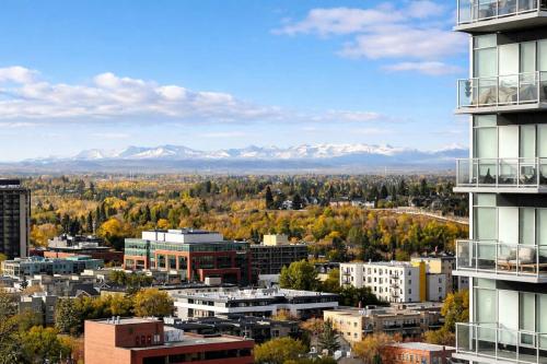 a view of a city with mountains in the background at Summit Mountain & Skyline Views Beltline in Calgary