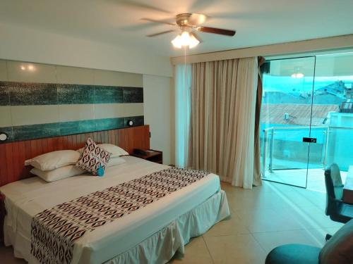 a bedroom with a bed with a ceiling fan at Samiria Jungle Hotel in Iquitos