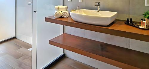 a bathroom with a sink on a wooden counter at Reserva Madero Loft in Natal