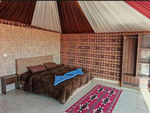 a bedroom with a large bed in a tent at Starlit Wadi Rum camp in Wadi Rum