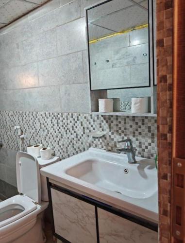 a bathroom with a sink and a toilet at Starlit Wadi Rum camp in Wadi Rum
