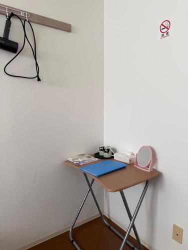 a desk in a room with a phone on a wall at Kinjiro Hotel in Tokyo