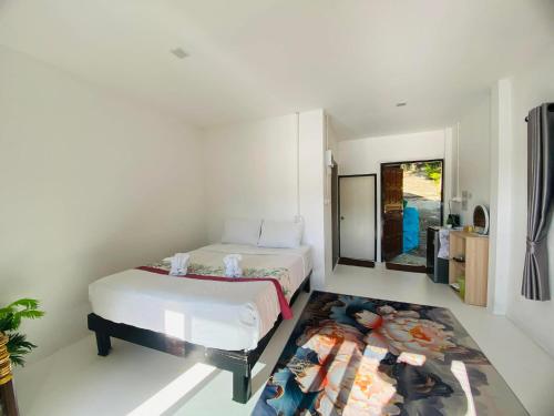 a bedroom with a bed and a rug on the floor at Paradise view A7-Kantiang paradise resort- in Ko Bu Bu