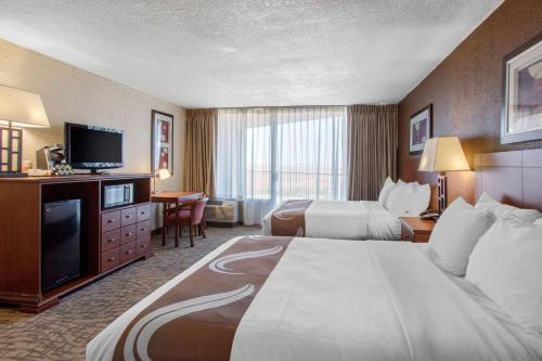 a hotel room with two beds and a flat screen tv at Scenic View Inn - Lake Powell - Page AZ in Page