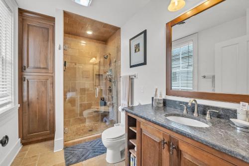 a bathroom with a sink and a toilet and a shower at Moore on Main in Abingdon
