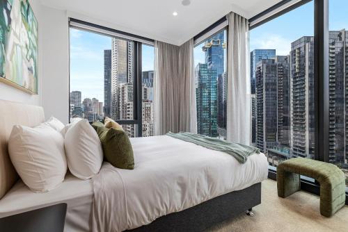 a bedroom with a bed and a large window at The Signature Melbourne Modern Nostalgia in Melbourne