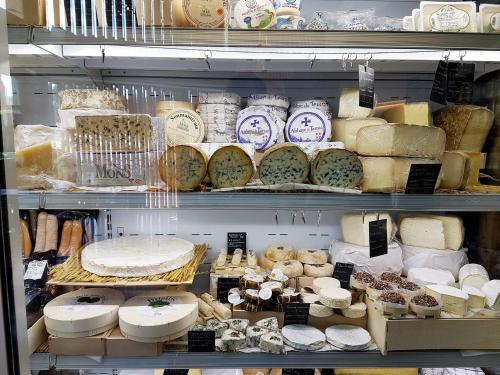a refrigerator filled with lots of different types of cheese at Sofouli Suites in Nicosia