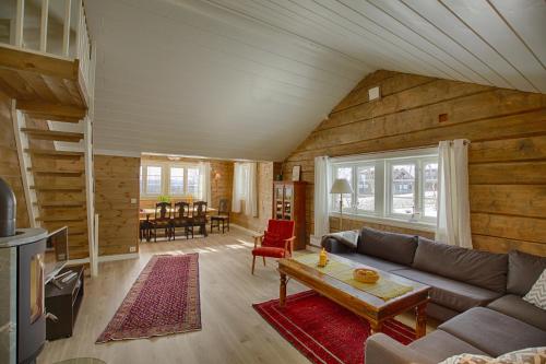 a living room with a couch and a table at Modern Comforts, and Ski Access in Beitostøl