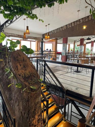 a large tree stump sitting in the middle of a restaurant at My Honey's Farm in Nangkaan