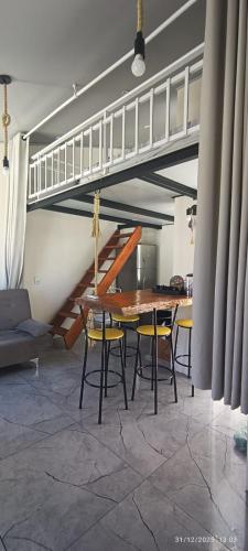 a dining room with a table and chairs and a staircase at Casa Belíssima in Pelotas