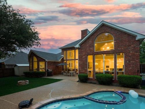 a house with a swimming pool in front of it at Captivating 6BR 3B Home with Pool & Fire Pit in Mesquite