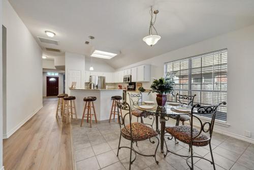 a kitchen and dining room with a table and chairs at 4BD Cozy Frisco Fun Stay! in Frisco