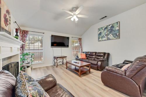 a living room with leather furniture and a flat screen tv at 4BD Cozy Frisco Fun Stay! in Frisco