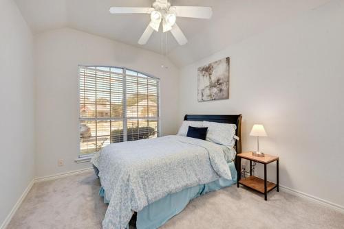a bedroom with a bed and a ceiling fan at 4BD Cozy Frisco Fun Stay! in Frisco