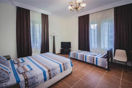 A bed or beds in a room at Marshal Resort Kobuleti
