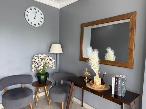 a living room with a mirror and a table and chairs at Royale City Hotel - 10 min from KLIA KLIA 2 Airport in Sepang