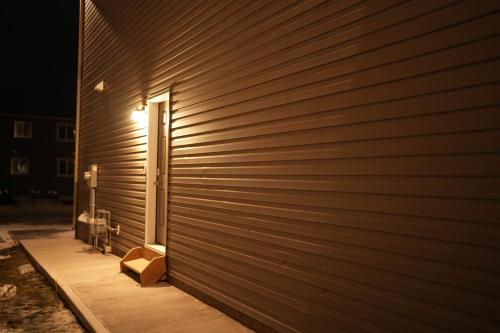 a wooden wall with a door and a box on it at Cozzy Cityscape & Airport Retreat in Calgary