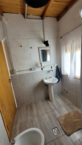 a small bathroom with a sink and a toilet at Casa Lavion in Colonia Chapadmalal