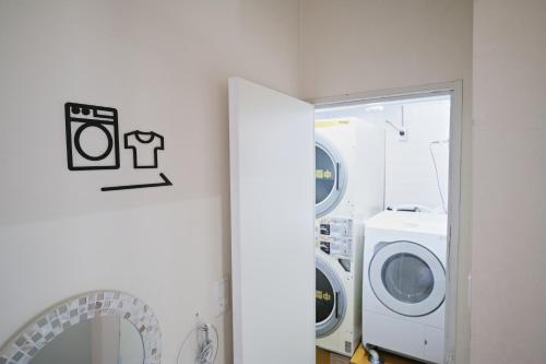a laundry room with a washer and dryer at Casa Blanca Guesthouse in Nagasaki