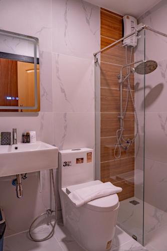 a bathroom with a toilet and a sink and a shower at The View A-Frame Cabin in Chiang Dao
