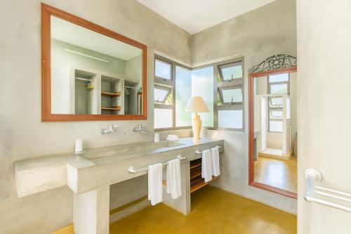 a bathroom with a sink and a mirror at Villa Alizée Boutique Hotel - Idéal Couples & Pros - Rooftop in Port Louis