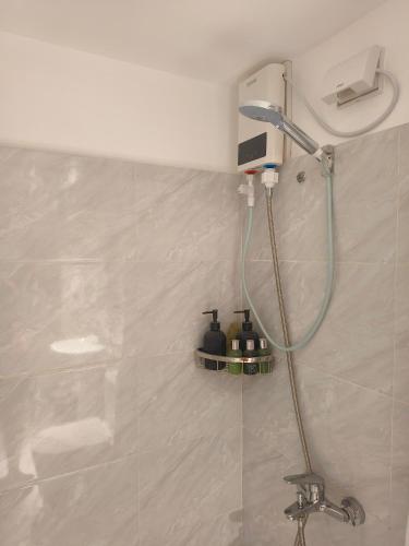 a shower in a bathroom with a sink at Arc Tower Cebu 1714 in Cebu City