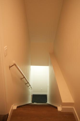 a staircase in a room with a stair case at Cozzy Cityscape & Airport Retreat in Calgary