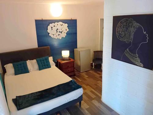 En eller flere senge i et værelse på hôtel Oasis