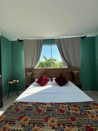 a bedroom with a large bed with a window at Yopo Resort in Yopal
