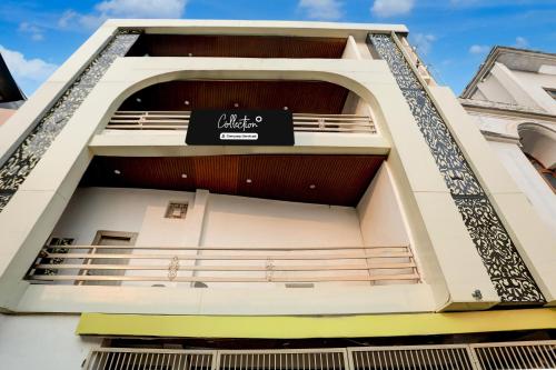 a building with a sign on the side of it at OYO Collection O George Town in Colonelganj
