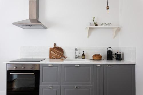 a kitchen with a sink and a stove at King Bed Studio in the Heart of Richmond in Richmond