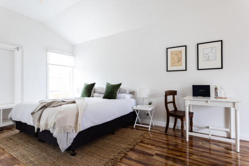 a bedroom with a bed and a table and a chair at King Bed Studio in the Heart of Richmond in Richmond