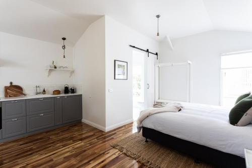 a bedroom with a large bed and a kitchen at King Bed Studio in the Heart of Richmond in Richmond