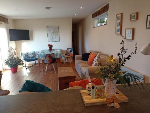 a living room with a couch and a table at Long Barn Wales in Monmouth