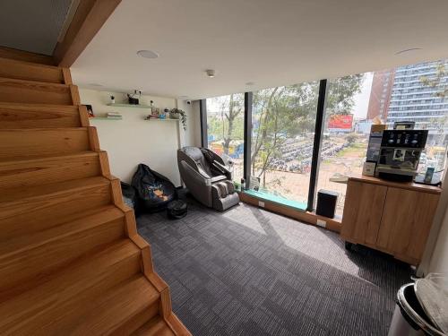 a room with a staircase with a chair and a window at Nap Junction in Pune