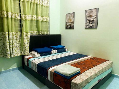 a small bed in a room with a window at Azihar Homestay Marang in Marang