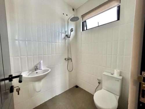 a bathroom with a toilet and a sink at SanSan Home in Jimbaran