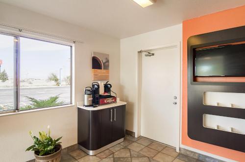 a room with a large window and a flat screen tv at Motel 6-Laramie, WY in Laramie