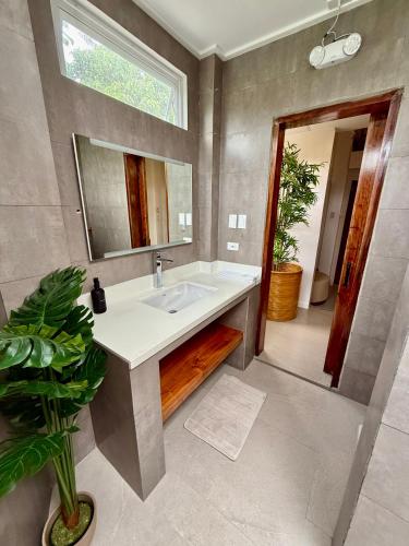 a bathroom with a sink and a mirror at The Wander Nest Villas in Panglao Island