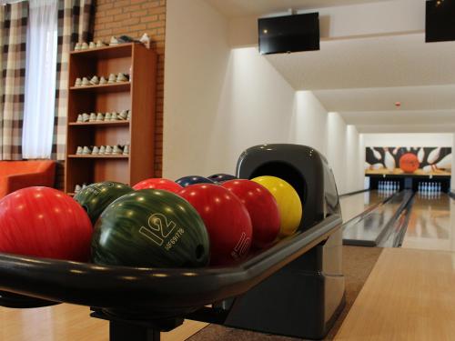 a bowl of bowling balls in a bowling alley at Penzion Pod zámkom-Boleráz in Boleráz