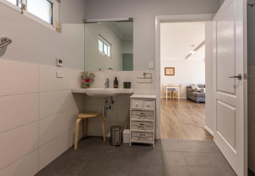 a white kitchen with a sink and a counter at Topp House Retreat in Bethany
