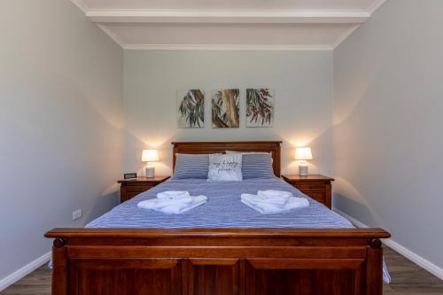 a bedroom with a bed with two towels on it at Topp House Retreat in Bethany