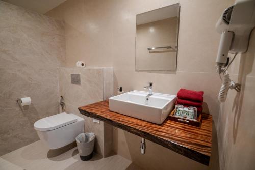 a bathroom with a sink and a toilet at Crystal Bay Yacht Club Beach Resort in Lamai