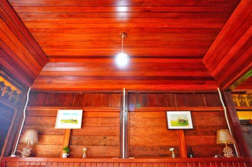 a room with a wooden ceiling with a light at Pondok Panglima Awang in Pantai Cenang
